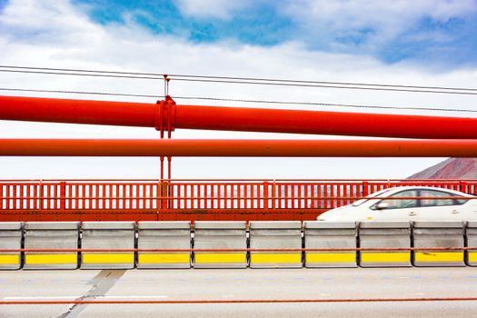 a fast car moving over golden gate bridge