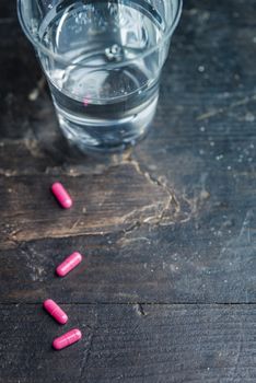 Pills and medicine over a dark table and backrgound.