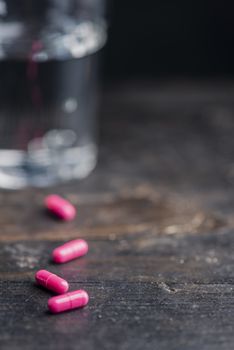Pills and medicine over a dark table and backrgound.