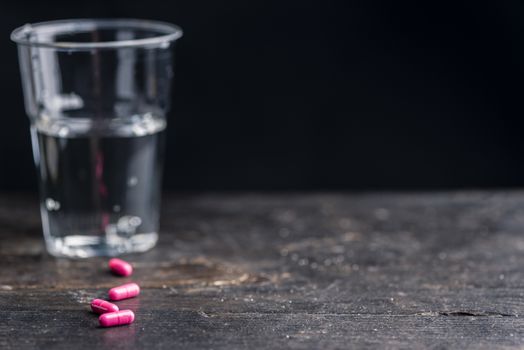 Pills and medicine over a dark table and backrgound.