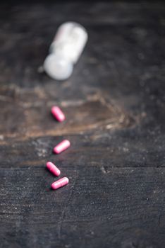 Pills and medicine over a dark table and backrgound.