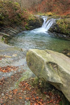 boulder near mountain river with  in the forest near the mountain slope