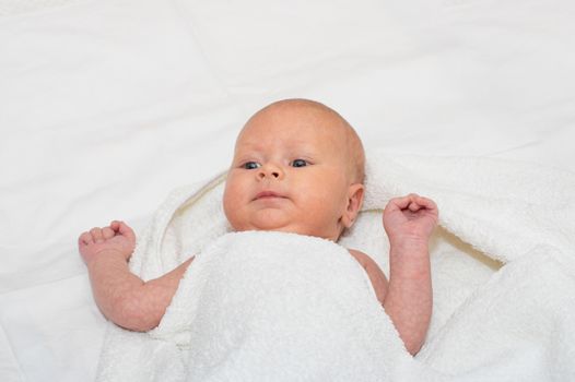 Close up shot of boy newborn jaundice lying on white bed sheet