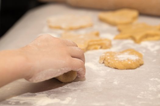Children's hands make gingerbread from dough