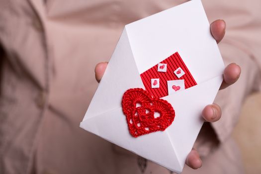 The girl is holding a valentine