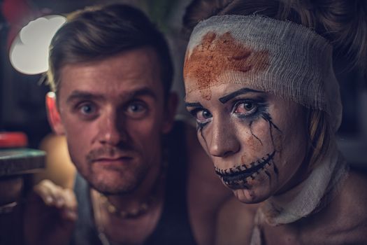 Horrible girl with her boyfriend, zombie halloween theme