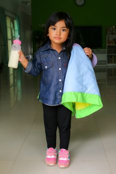 Little girl drinking milk in my home