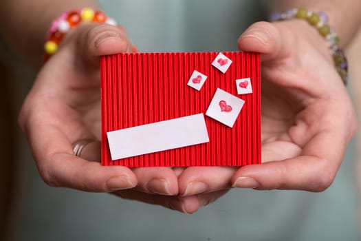 The girl is holding a valentine