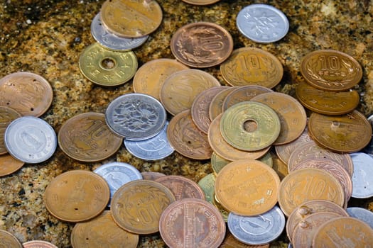 Japanese coin was thrown by traveler into wishing well in Kyoto, Japan.