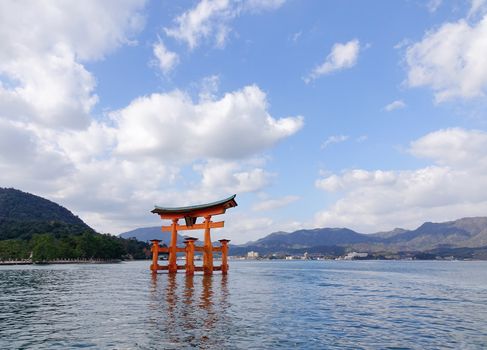 Floating gate (Giant Torii) of Itsukushima Shrine under blue sky in Hiroshima, Japan. The temple is a UNESCO World Heritage Site.