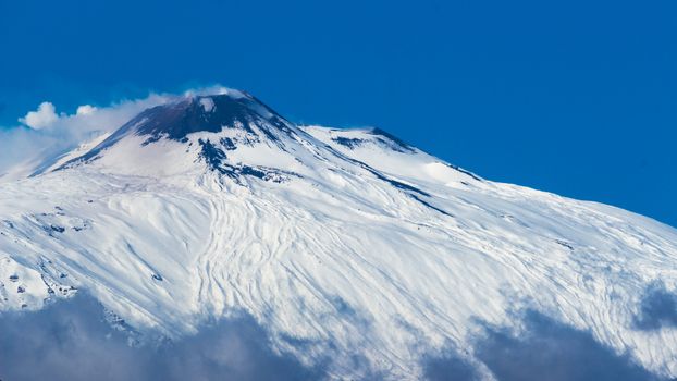 view of the Etna volcano covered by the laste sping snow