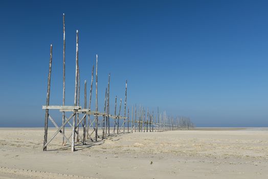 Old pier on the sandbar the Vliehors on the island of Vlieland in the Netherlands
