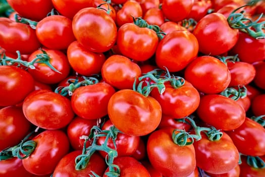 Many red tomatoes at the market macro close up