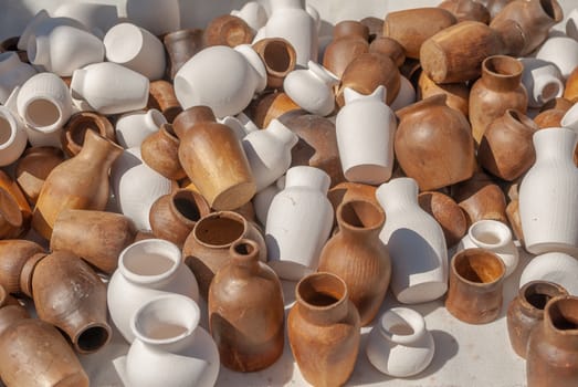 decorative jugs made of wood white and brown color, a beautiful sunny day