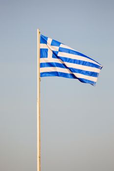 Greek flag floating on a white mat on the island of Crete
