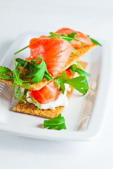 Smoked Salmon on a Healthy Crispbread with Cream Cheese, Fresh Arugula 
