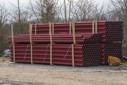 Stockyard of various tubes and pipes at a construction site.
