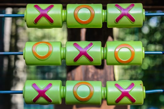 Tic-tac-toe game on the playground in sunny weather