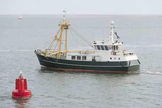 Fishing boat on the Wadden Sea near the island of Vlieland in the North of the Netherlands
