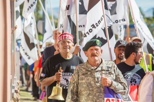 NOGALES, AZ - OCTOBER 08: Large group of people with flags and bells protesting the treatment of deported veterans on October 08, 2016 in Nogales, AZ, USA.