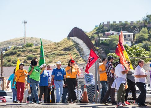 NOGALES, AZ - OCTOBER 08: Group of men and women with flags protesting border policies on October 08, 2016 in Nogales, AZ, USA.