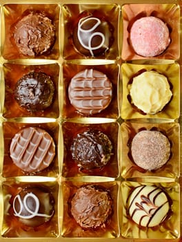 Top View of Belgian Chocolate Pralines in the Box. Sweet Pralines Close Up Background.