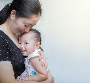 mother and child hugging and smile at home