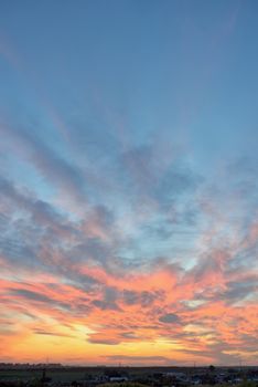 Dramatic sunset over city in spring time