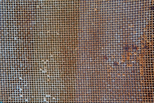 Old rusty mesh in blurring. Colorful pattern. Metal rusty fences.