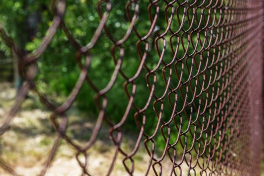 Old rusty mesh in blurring. Colorful pattern. Metal rusty fences.