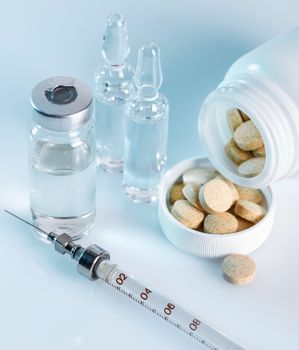 background, a variety of medical drugs and syringe closeup