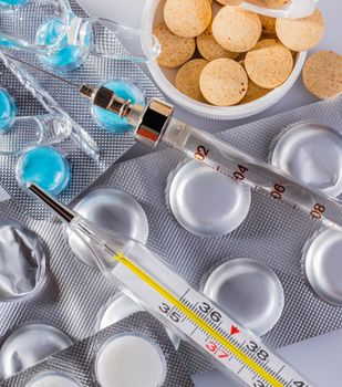 background, a variety of medical drugs and syringe closeup