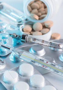 background, a variety of medical drugs and syringe closeup