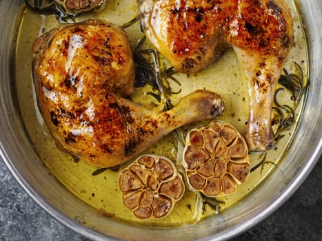 close up of rustic italian roast chicken with garlic and rosemary