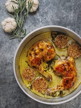 close up of rustic italian roast chicken with garlic and rosemary