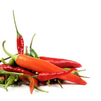 Stack of Perfect Red, Orange and Green Hot Chili Peppers Cross Section on White background