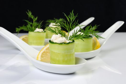 Cucumber canape with ricotta and lemon slice close-up. Horizontal shot. Foreground.