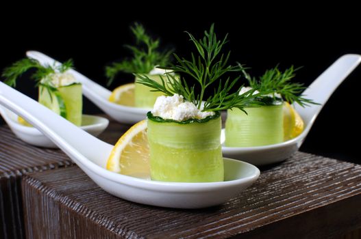 Cucumber canape with ricotta and lemon slice close-up. Horizontal shot. Foreground.