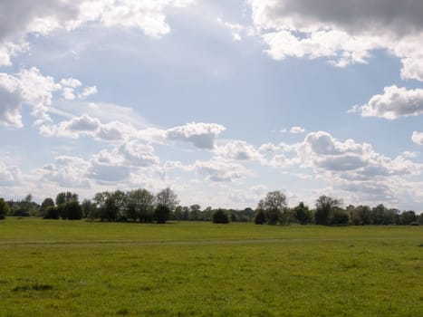 a walking path through an open countryside in the heartland of constable country essex england in the uk with no people and a clear sky on a summer afternoon heavenly