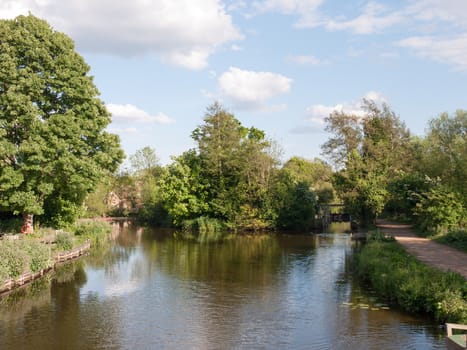 the lake at flatford mill outside in the country in essex on a bright and clear sunny day with no people location and holiday tourist spot with natural beauty looking peaceful and happy