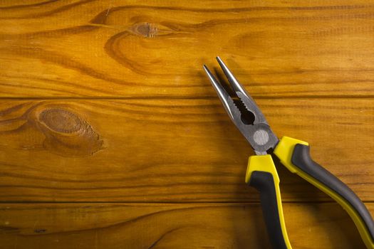 Close up of a multitool pliers on wooden background