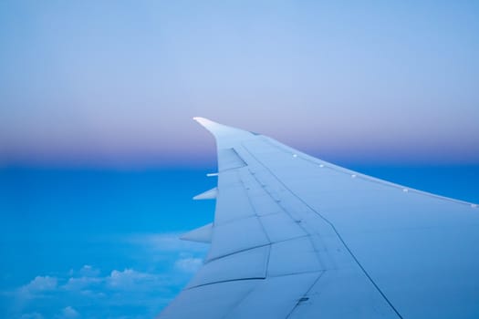 wing of an airplane flying above the clouds