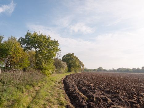 a plowed farm land ready to be sown and for crop to grow starting outside spring lush countryside  peaceful growing