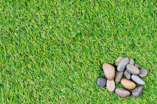 small stone on grass background