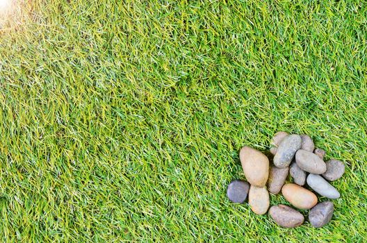 small stone on grass background