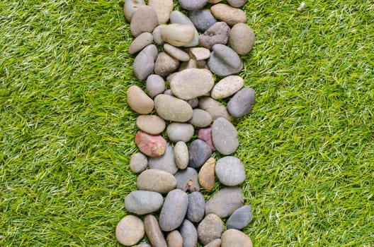 small stone on grass background