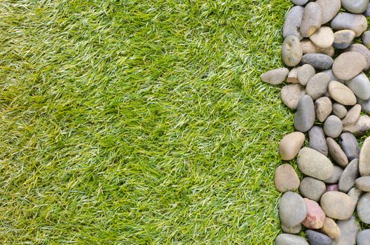 small stone on grass background