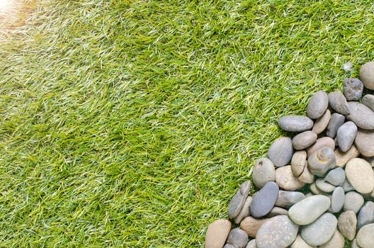 small stone on grass background