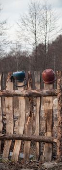 Old wooden boundary fence with nails on sunny day