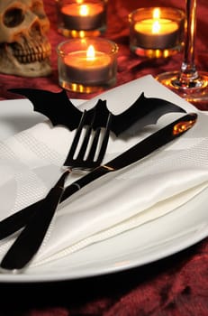 Knife and fork decorated with a bat on a napkin on Halloween as an element of the table serving